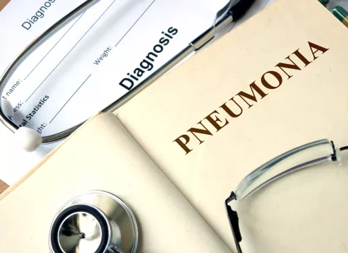 Pneumonia book with glasses and a stethoscope on top
