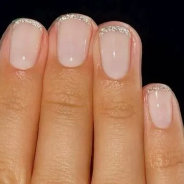 Short nails with micro-French design and glitter