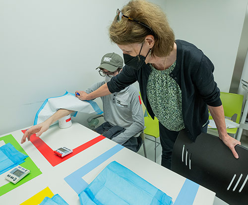 Dr. Kirsten Lyke with a study volunteer who was exposed to infectious mosquitoes with the malaria parasite