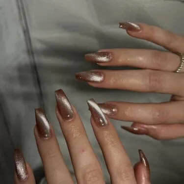 A close up of long cashmere nails